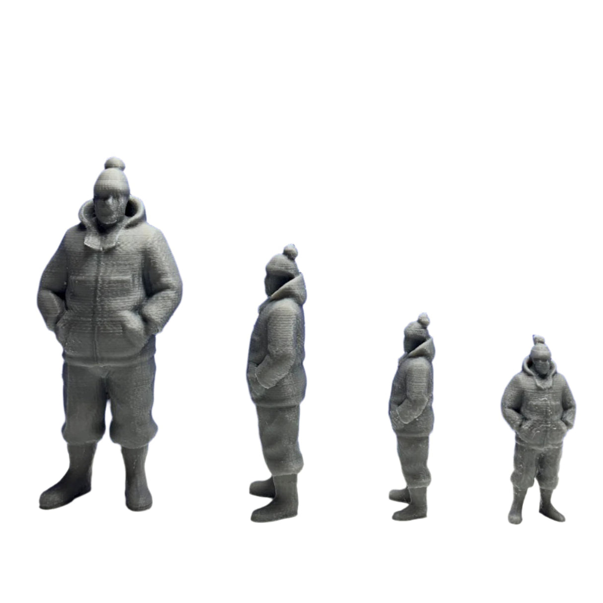 Four 3D printed trawler fishermen models wearing waterproof jackets, boots, and bobble hats, displayed by size for model boats