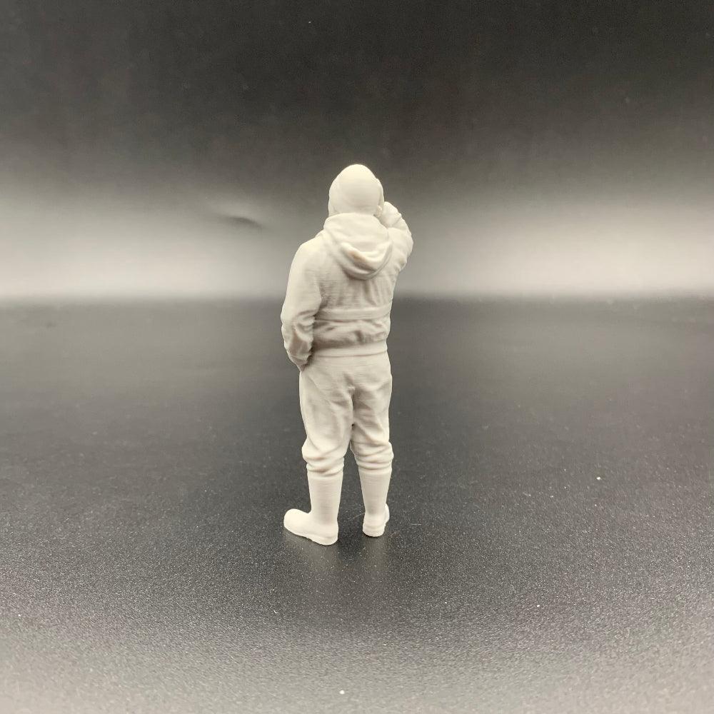 Scale model fisherman wearing lifejacket standing with hand to head for boat and harbour scenes