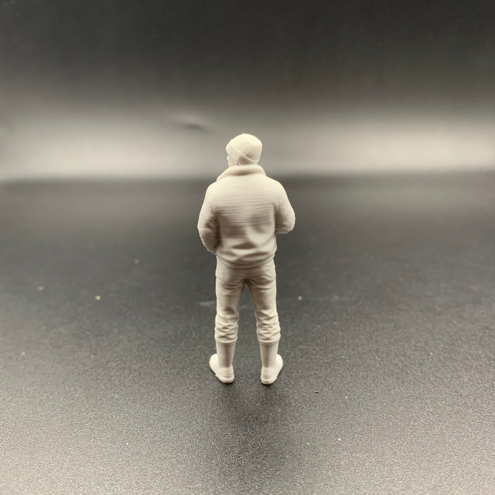 Unpainted 3D printed crew figure carrying a cup of tea or coffee for maritime and railway layouts