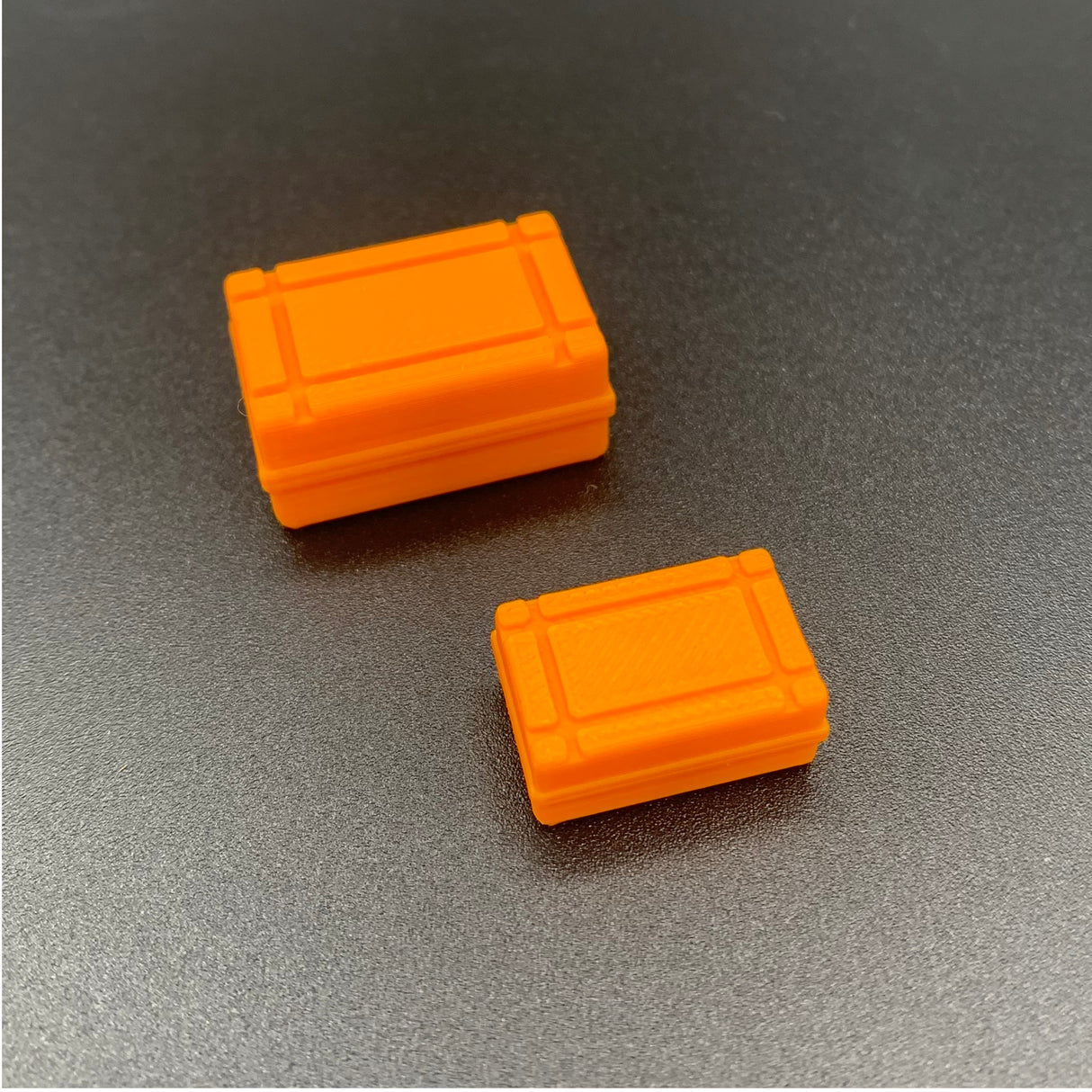 Orange rectangular liferaft canister for model boats, based on a 4-person liferaft, shown in scale