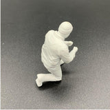 Scale kneeling deckhand figure on model boat deck