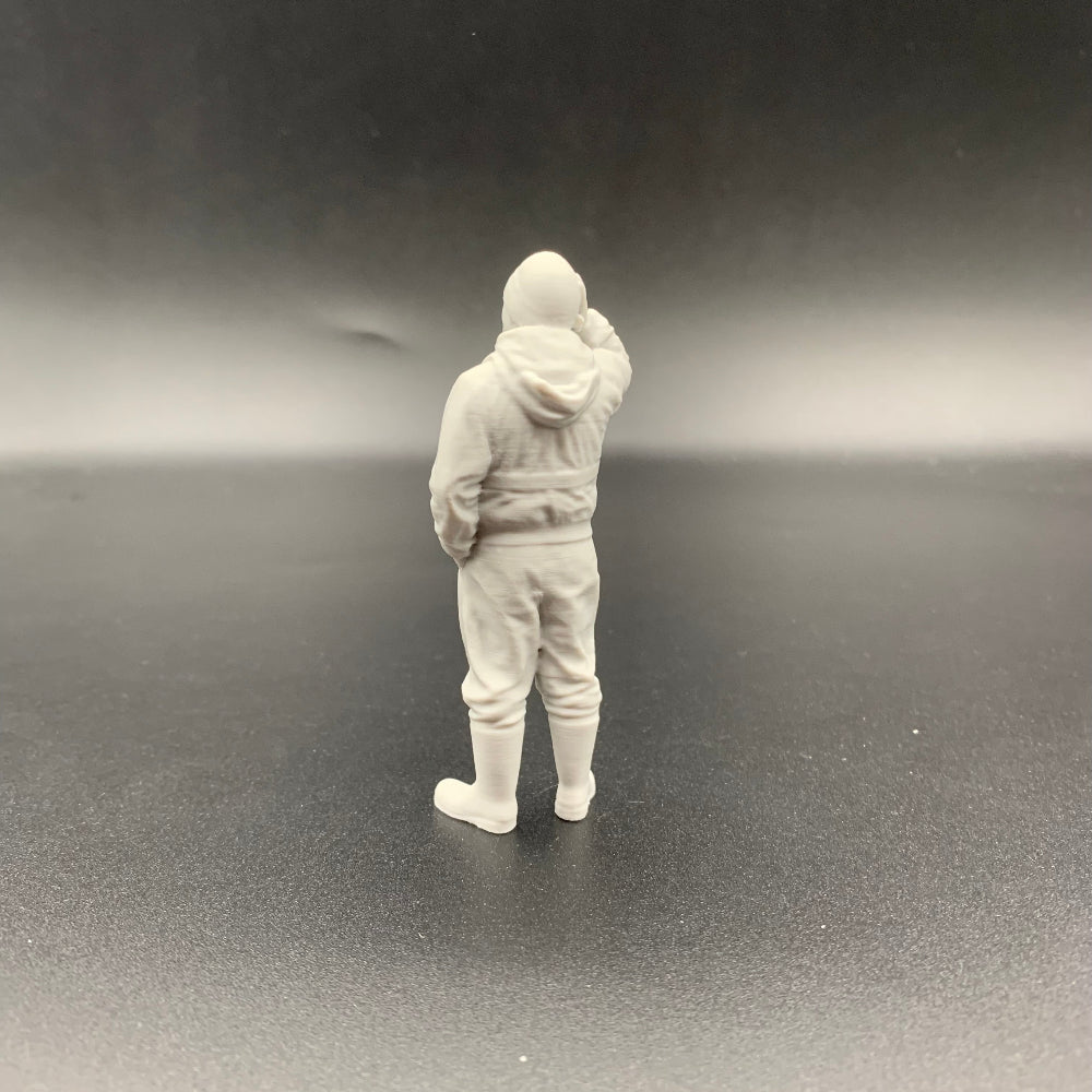 Scale model fisherman wearing lifejacket standing with hand to head for boat and harbour scenes